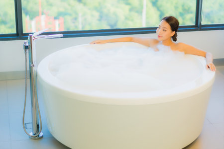 Portrait beautiful young asian woman relax leisure enjoy in bathtub at bathroom and toilet interiorの写真素材
