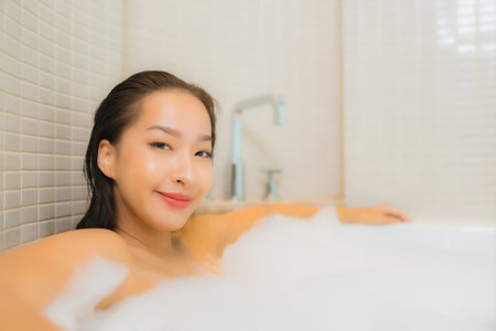 Portrait beautiful young asian woman relax leisure enjoy in bathtub at bathroom and toilet interiorの写真素材