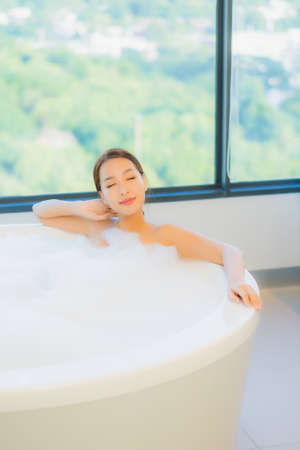 Portrait beautiful young asian woman relax leisure enjoy in bathtub at bathroom and toilet interiorの写真素材