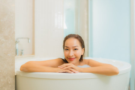 Portrait beautiful young asian woman relax leisure enjoy in bathtub at bathroom and toilet interior