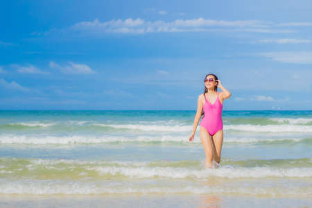 Portrait beautiful young asian woman relax smile around beach sea ocean in holiday vacation travel tripの写真素材