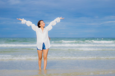 Portrait beautiful young asian woman relax smile around beach sea ocean in holiday vacation travel tripの写真素材