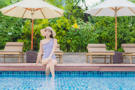 Portrait beautiful young asian woman relax smile leisure around outdoor swimming pool in holiday vacation travel tripsの写真素材
