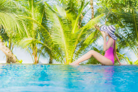 Portrait beautiful young asian woman use smart mobile phone on bed in bedroom interiorの写真素材