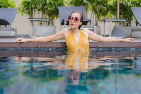 Portrait beautiful young asian woman relax leisure around swimming pool in hotel resort