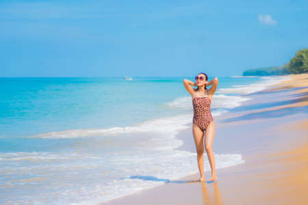 Portrait beautiful young asian woman relax leisure around outdoor beach sea ocean in travel vacationの写真素材