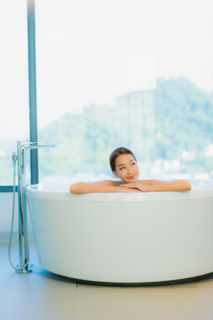 Portrait beautiful young asian woman relax enjoy smile around outdoor swimming pool in hotel resort...