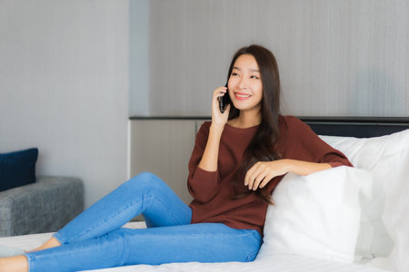 Portrait beautiful young asian woman enjoy relax smile leisure around outdoor swimming pool in hotel resort for holiday vacationの写真素材