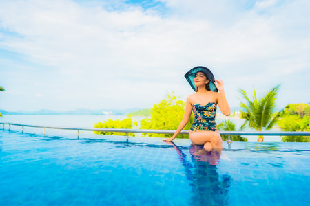 Portrait beautiful young asian woman relax smile leisure around sea beach ocean with white cloud on...