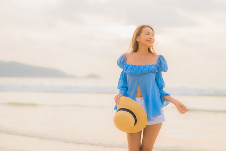 Portrait beautiful young asian woman relax smile leisure around outdoor tropical sea beach ocean in travel vacationの写真素材