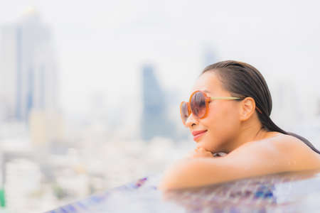 Portrait beautiful young asian woman relax smile leisure around outdoor swimming pool nearly sea beach in Travel vacationの写真素材