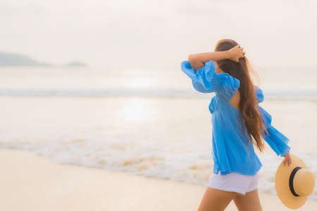 Portrait beautiful young asian woman relax smile leisure around outdoor swimming pool nearly sea beach in Travel vacationの写真素材