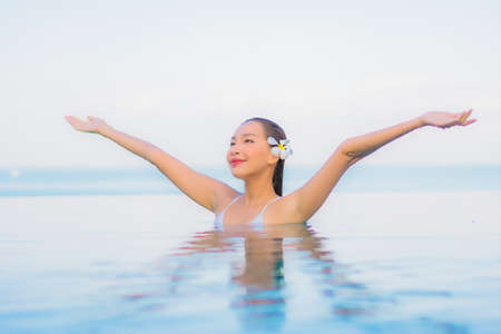 Portrait beautiful young asian woman relax smile leisure around outdoor swimming pool in hotel...