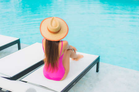 Portrait beautiful young asian woman relax smile around outdoor swimming pool in hotel resort nearly sea beach oceanの写真素材