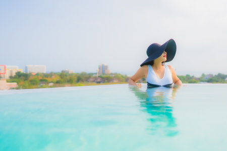 Portrait beautiful young asian woman relax smile leisure around outdoor sea beach ocean at sunset time for vacationの写真素材