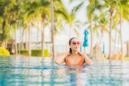 Portrait beautiful young asian doctor woman wear ppe or  personal protective equipment for protect from coronavirus or covid19 on blue isolated backgroundの写真素材