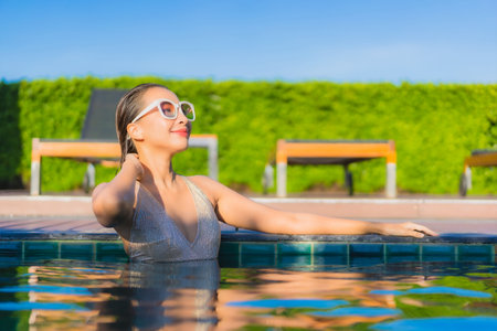 Portrait beautiful young asian woman relax smile leisure around outdoor swimming pool in hotel...