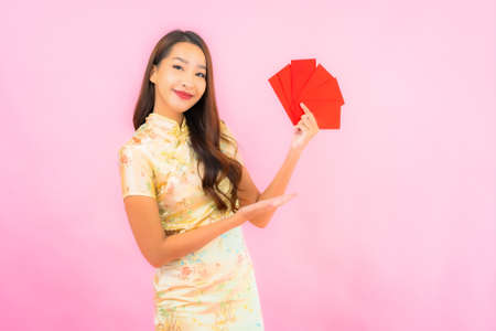 Portrait beautiful young asian woman with chinese new year concept  on color backgroundの写真素材