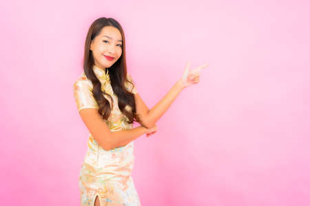 Portrait beautiful young asian woman with chinese new year concept  on color backgroundの写真素材