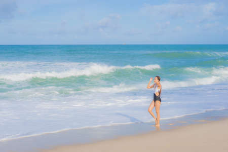 Portrait beautiful young asian woman relax smile around beach sea ocean in holiday vacation
