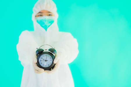 Portrait beautiful young asian woman wear mask for protect from covid19 or corona virus on color backgroundの写真素材