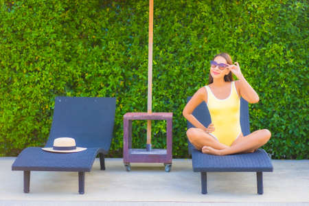 Portrait beautiful young asian woman relax smile enjoy leisure around swimming pool in resort hotel...