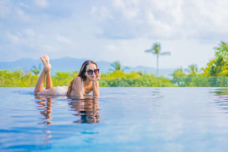 Portrait beautiful young asian woman relax smile leisure around outdoor swimming pool in resort...