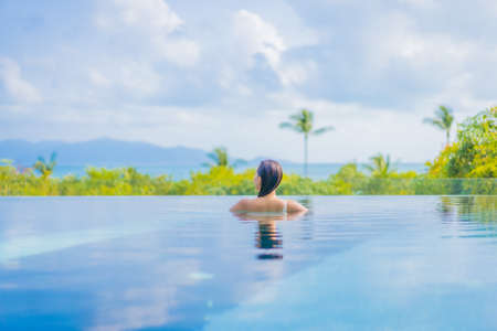 Portrait beautiful young asian woman relax smile leisure around outdoor swimming pool in hotel...