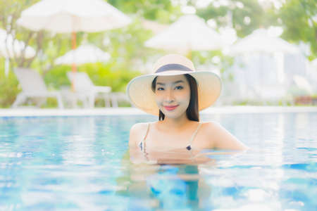 Portrait beautiful young asian woman relax smile enjoy leisure around swimming pool in resort hotel...