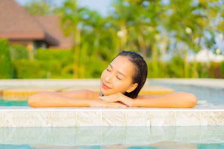 Portrait beautiful young asian woman leisure relax smile around outdoor swimming pool for vacation