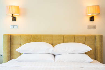 White pillow and blanket with light lamp decoration interior of bedroom