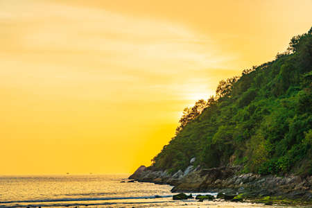 Beautiful sunset over mountain around beach sea ocean and rock for nature vacation backgroundの写真素材