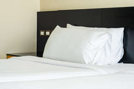 Pillow and blanket on bed with light lamp decoration interior of bedroomの写真素材