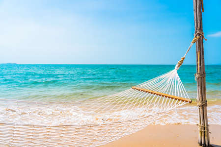 Empty white hammock around sea beach ocean for leisure travel vacation conceptの写真素材