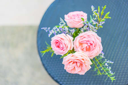 Beautiful flower in vase on table decoration with garden viewの写真素材