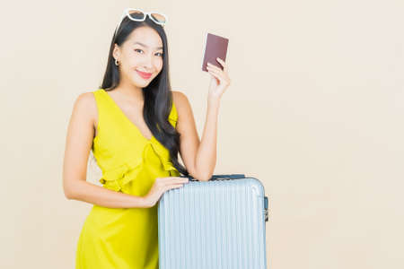 Portrait beautiful young asian woman smile with action on cream backgroundの写真素材
