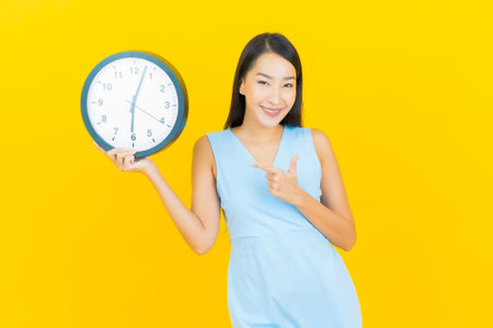Portrait beautiful young asian woman smile with action on yellow color background
