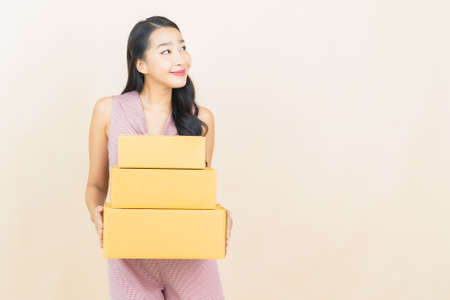 Portrait beautiful young asian woman smile with action on yellow color backgroundの写真素材
