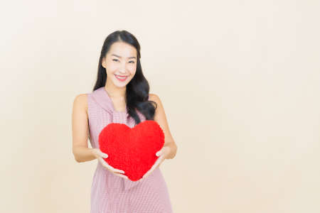 Portrait beautiful young asian woman smile with action on yellow color backgroundの写真素材