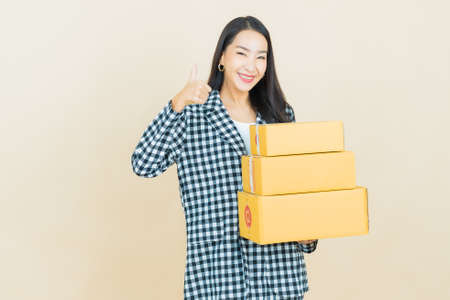 Portrait beautiful young asian woman smile with spoon and fork on color backgroundの写真素材