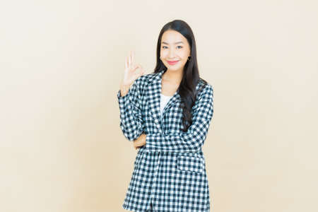 Portrait beautiful young asian woman smile with spoon and fork on color backgroundの写真素材