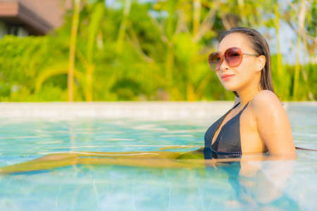 Portrait beautiful young asian woman relax smile leisure around outdoor swimming pool in hotel...