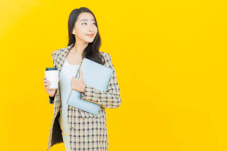 Portrait beautiful young asian woman smile with action on color backgroundの写真素材