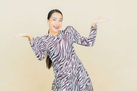Portrait beautiful young asian woman smile with action on color backgroundの写真素材