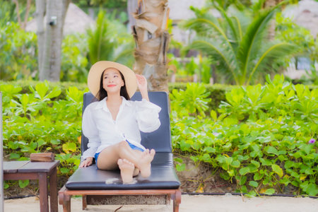 Portrait beautiful young asian woman relax smile around beach sea ocean in holiday vacation travel tripの写真素材