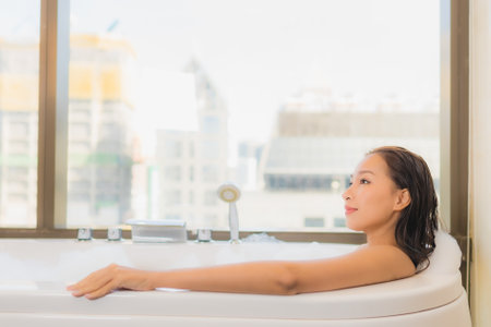 Portrait beautiful young asian woman relax enjoy take a bath at bathtub in bathroom interiorの写真素材
