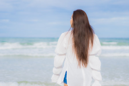 Portrait beautiful young asian woman relax smile around beach sea ocean in holiday vacation travel tripの写真素材