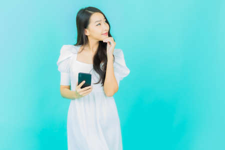 Portrait beautiful young asian woman with make up brush cosmetic on color backgroundの写真素材