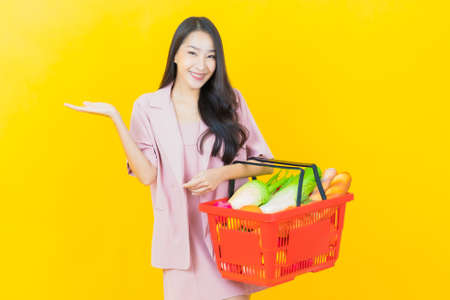 Portrait beautiful young asian woman with make up brush cosmetic on color backgroundの写真素材