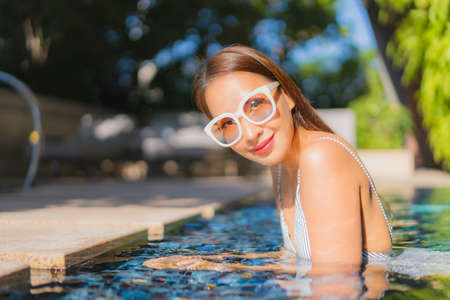 Portrait beautiful young asian woman relax smile in action on sofa in living room interiorの写真素材